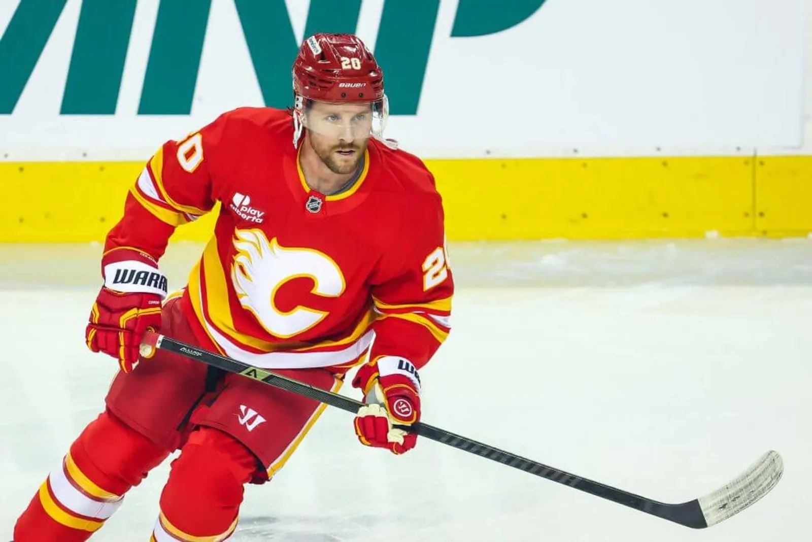 Wearing a red Flames jersey, Blake Coleman warms up before a game against the Kraken in January.