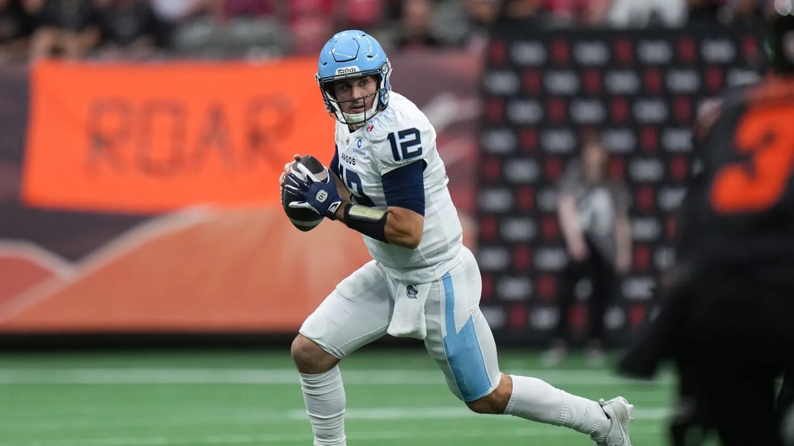 Toronto Argonauts quarterback Chad Kelly runs with the ball as he looks for a receiver during the first half of a CFL football game against the B.C. Lions in Vancouver, on Saturday, July 25, 2025. THE CANADIAN PRESS/Darryl Dyck